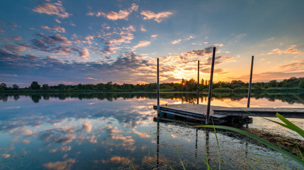istock Jetty on the lake at sunset in a romantic mood 1363326185
