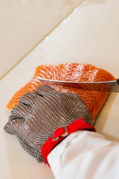 a professional cutting fish - uitbeenhandschoen stockfoto's en -beelden