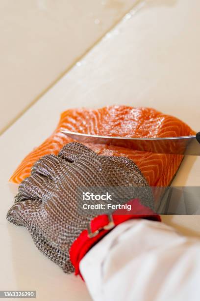 A Professional Cutting Fish Stock Photo - Download Image Now - Cutting, Protective Glove, Food