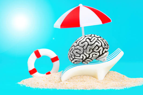istock Human brain relaxing under a sun umbrella on a sandy beach 1363330039