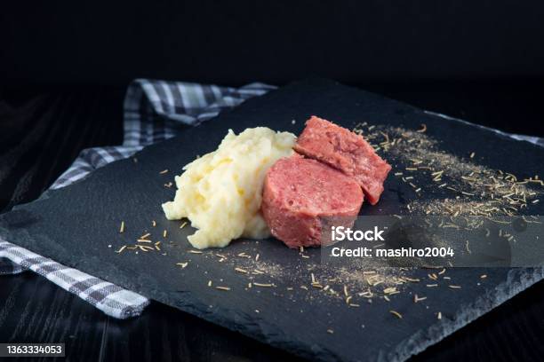 Cotechino And Mashed Potatoes In The Foreground Stock Photo - Download Image Now - Animal Body Part, Boiled, Close-up