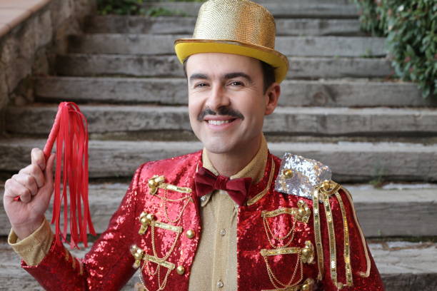 istock Elegant ringmaster holding red leather whip 1363334859