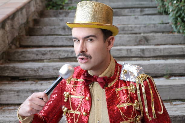 istock Elegant host wearing flashy outfit holding a microphone 1363334865
