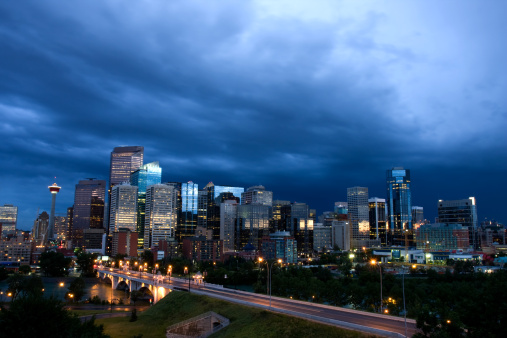 Calgary skyline under stormy skies.