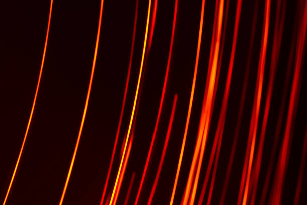 istock Bright red diagonal vertical lines of rays on a dark background. Abstract 1363336225
