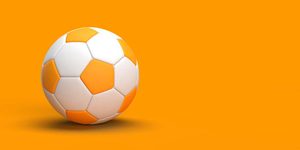 balón de fútbol sobre fondo naranja con espacio de copia - portería artículos deportivos fotografías e imágenes de stock