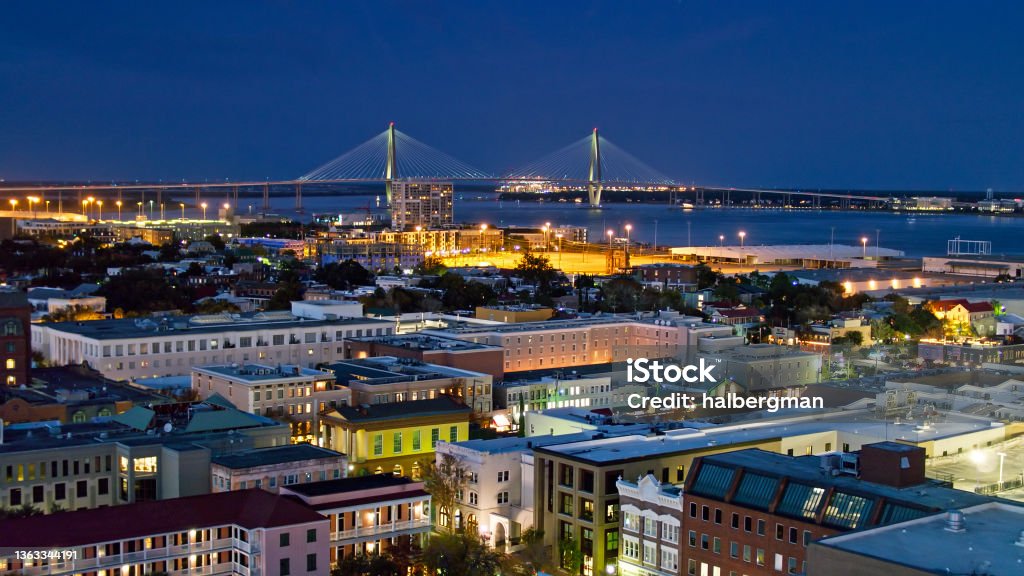 Downtown Charleston at Twilight - Aerial Aerial shot of Downtown Charleston, South Carolina at twilight, flying over the French Quarter and looking towards the Cooper River Bridge. South Carolina Stock Photo
