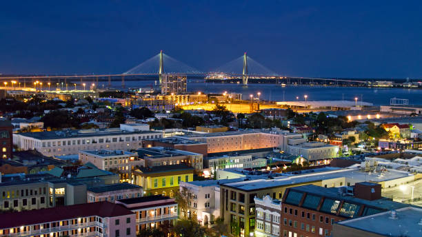 Downtown Charleston at Twilight - Aerial Aerial shot of Downtown Charleston, South Carolina at twilight, flying over the French Quarter and looking towards the Cooper River Bridge. charleston south carolina stock pictures, royalty-free photos & images