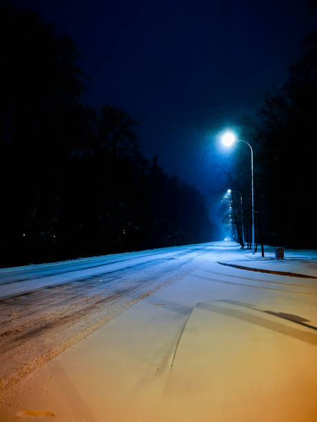 istock Glowing city lights at dark snowy morning 1363345082