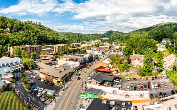 Aerial view of Gatlinburg, Tennessee Aerial view of Gatlinburg above US-441. Gatlinburg is a popular mountain resort city in Sevier County, Tennessee, as it rests on the border of Great Smoky Mountains National Park. gatlinburg stock pictures, royalty-free photos & images