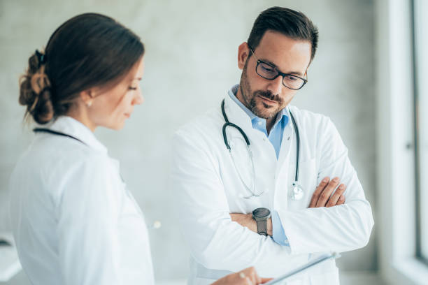 istock Two healthcare workers talking at hospital 1363346060