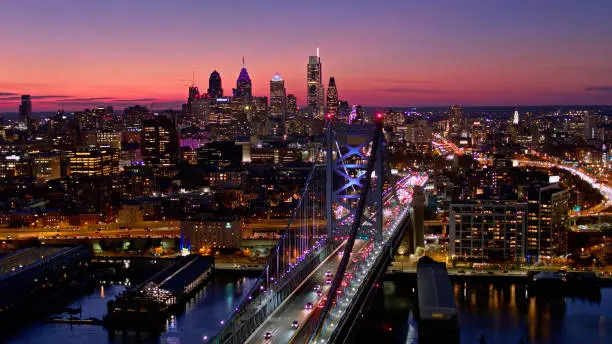 Aerial shot of evening traffic between Philadelphia, Pennsylvania and Camden, New Jersey on Ben Franklin Bridge after sunset