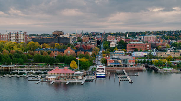 Aerial View Over Ferry Terminal Towards Downtown Burlington, VT Aerial shot of Burlington, Vermont at sunset on a Fall evening, flying over the water of  Lake Champlain and the ferry terminal, where a line of people is slowly boarding, looking towards the city and the fall colors of the trees.  The Green Mountains can be seen in the distance. 

Authorization was obtained from the FAA for this operation in restricted airspace. green mountains appalachians photos stock pictures, royalty-free photos & images