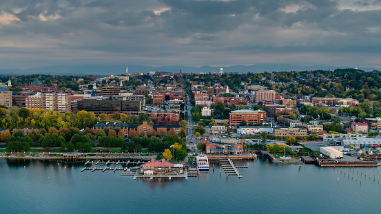 Aerial shot of Burlington, Vermont at sunset on a Fall evening, from over the water of  Lake Champlain and looking towards the city and the fall colors of the trees. The Green Mountains can be seen in the distance. 


Authorization was obtained from the FAA for this operation in restricted airspace.