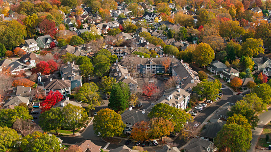 Empty deserted children's Playground and paths in the courtyard of a residential neighborhood covered with autumn leaves. Autumn urban desolate landscape. Top view.