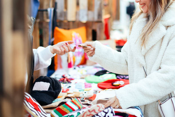 istock Woman purchasing clothes with credit card 1363351855
