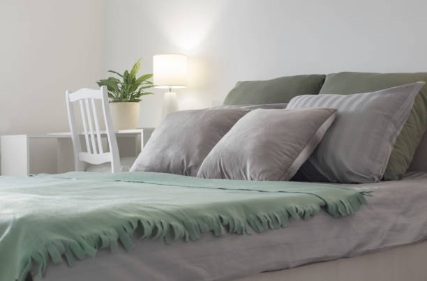 istock white bedroom with gray and green linens 1363352552