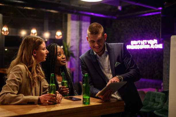 istock Cheerful colleagues drinking beer in the bar together after work 1363352723