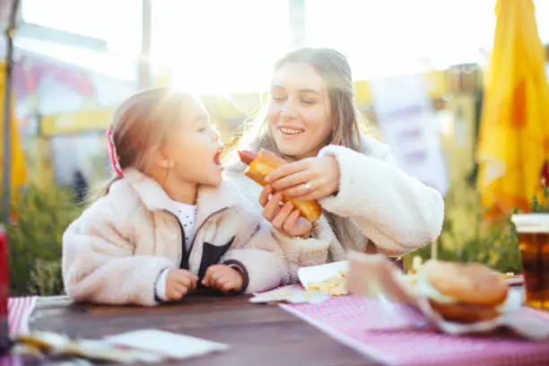 Young mother and daughter enjoying lunch time.