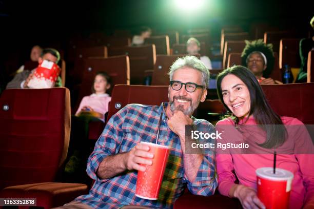 Man And Woman Enjoying Watching A Movie At The Cinema Stock Photo - Download Image Now