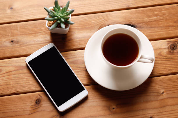 istock Wood background with smartphone and coffee 1363352853