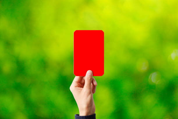 istock Person with red card and green blur background 1363353734