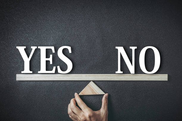 Yes and no seesaw balance black background