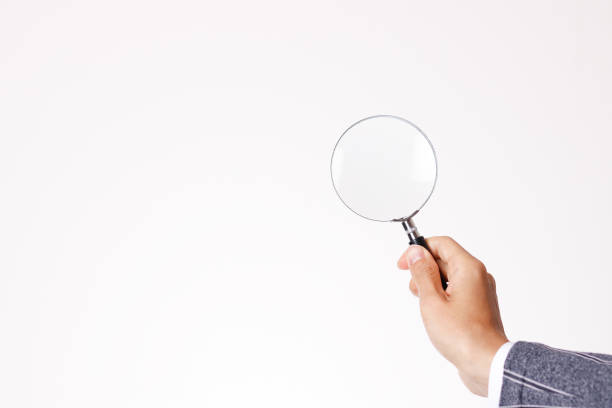 istock Businessman with loupe in hand 1363354828