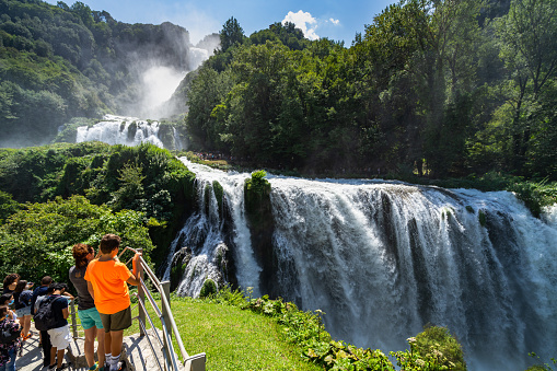 Terni, Italy, Aug. 2021 – Tourists visiting the scenic Cascata delle Marmore (Marmore falls) during summer.