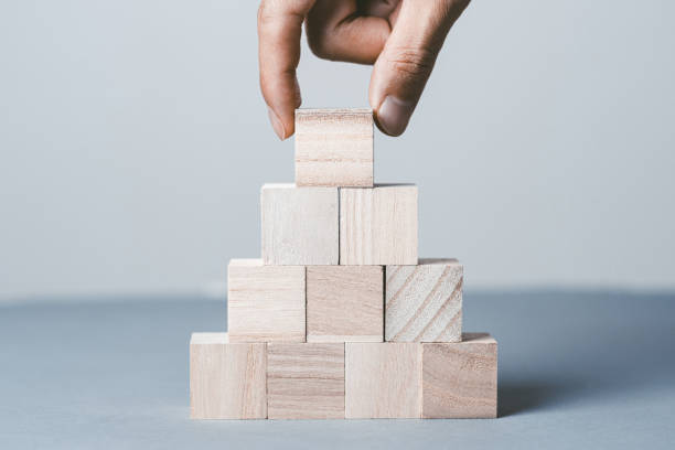 istock Gray background with stacked wooden blocks 1363359472
