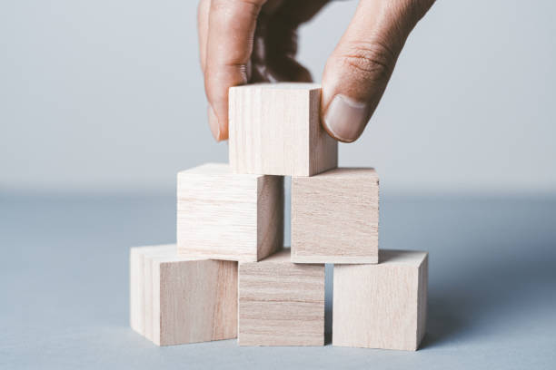 istock Gray background with stacked wooden blocks 1363359650