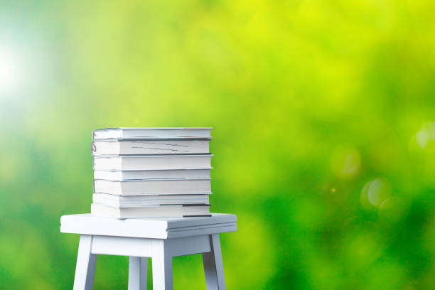 Stacked books and green blur background