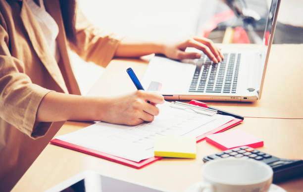 istock Business woman working in office with laptop computer and documents 1363361848