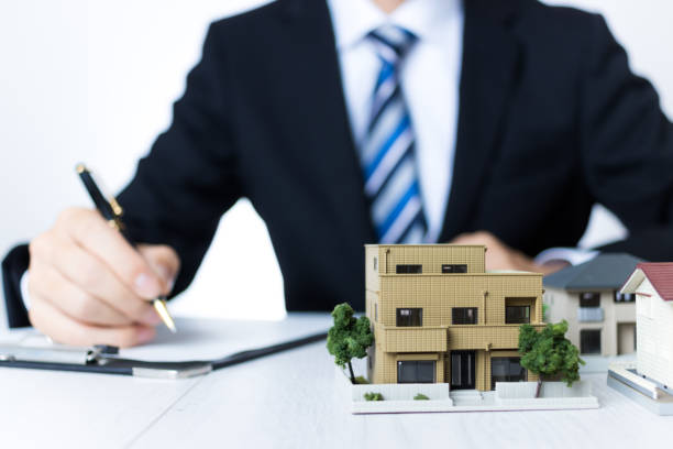 istock Businessman in a suit selling homes 1363362119