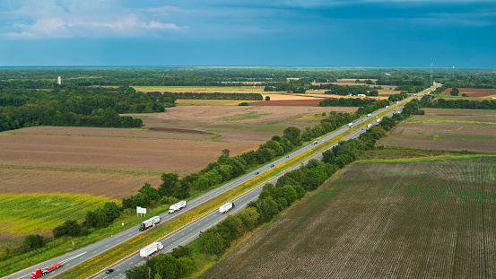 Drone shot of Interstate 40 crossing farmland in Prairie County, Arkansas, near the town of Biscoe.