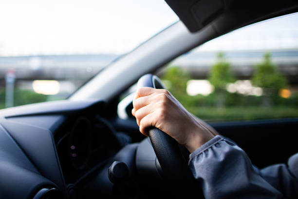 istock Driving a car and a woman's hand 1363363587