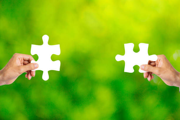 istock White puzzle piece and green blur background 1363365208