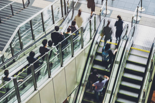 istock People using the escalator at the station 1363366588