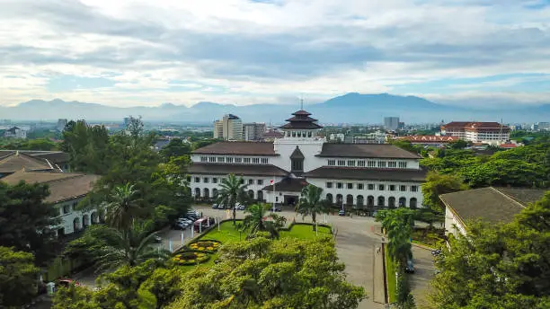Photo of Aerial view of Gedung Sate, Bandung, West Java, Indonesia with beautiful sky and city landscape. Old Historical building with art decoration style, Governor Office