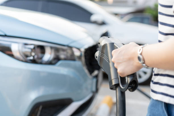 istock Woman charging her electric car - EV 1363373351