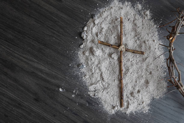 istock Wood cross on ashes with partial crown of thorns 1363375269