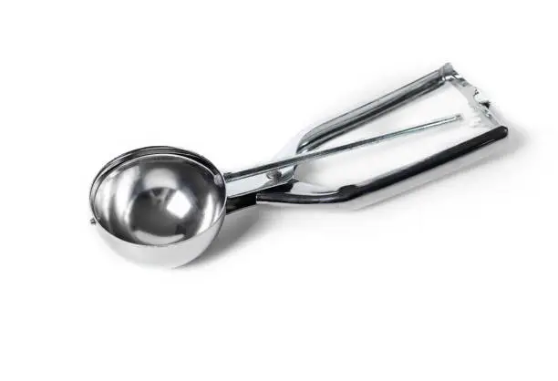 Stainless steel kitchen tool or gadget, to evenly proportion out dough, batter or ice cream. Isolated. Selective focus.