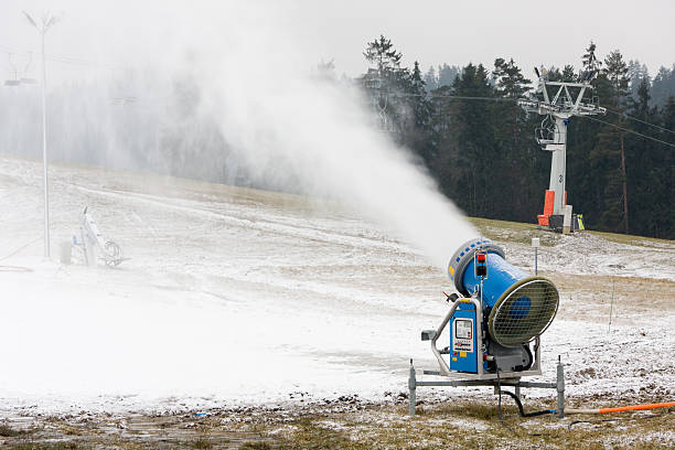 Snow making machine on a slope stock photo