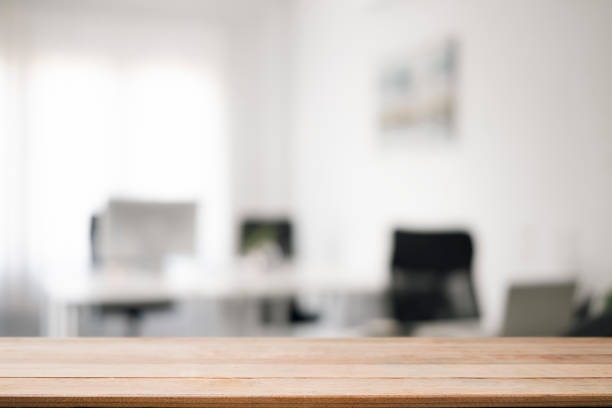 istock Empty wooden table with blurred modern office background. Copy space for display of product. 1363382556