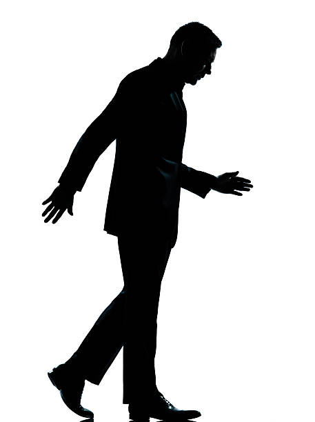 istock one business man walking looking down silhouette 136338585