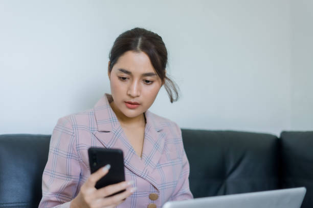 istock business woman using a mobile phone 1363385955