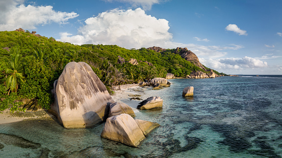 La Digue Anse Source d'Argent Beach at Anse Union Coast. Drone Point of the famous Anse Union Coast and Anse Source d'Argent Beach with it’s famous granite boulder rock formations and crystal clear ocean on La Digue Island. Stiched XXL DJI Mavic 3 Drone Panorama in warm sunset light. Anse Union, La Digue Island, Seychelles Islands, East Africa