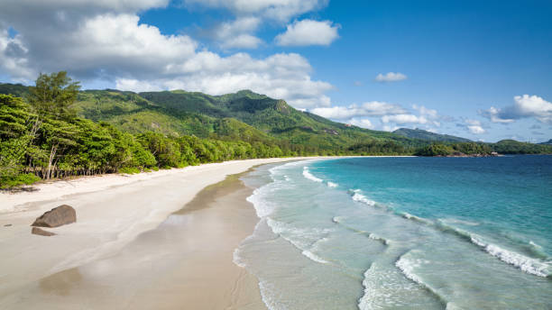 Seychelles Beach Grand Anse Panorama Mahé Island Beautiful Grand Anse Beach Panorama. Empty Beach on Mahé Island under blue summer skyscape. Grand Anse Beach, Mahé Island, Seychelles, East Africa mahe island stock pictures, royalty-free photos & images
