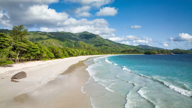 Seychelles Beach Grand Anse Panorama Mahé Island Beautiful Grand Anse Beach Panorama. Empty Beach on Mahé Island under blue summer skyscape. Grand Anse Beach, Mahé Island, Seychelles, East Africa praslin island stock pictures, royalty-free photos & images