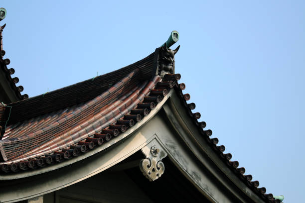 Japanese old style architecture roof tiling design texture under the blue sky.